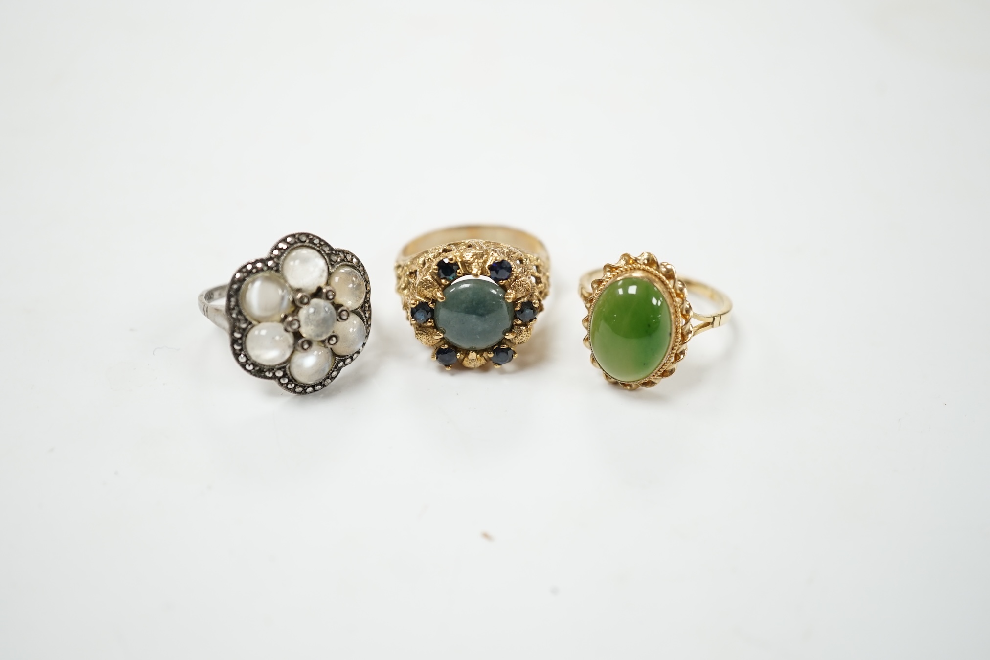 A 9ct gold and nephrite set ring, size P, one other 9ct and gem set ring and a German? Arts & Crafts 835, moonstone and marcasite cluster set ring. Condition - fair